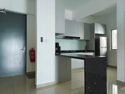 a kitchen with a black counter and a refrigerator at Metropol Serviced Apartment - Bukit Mertajam, Penang in Bukit Mertajam