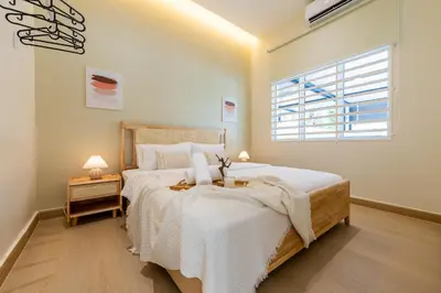 a bedroom with a large bed and a window at La Ferringhi Villa - Ryokan Collection, by ALV in Batu Ferringhi