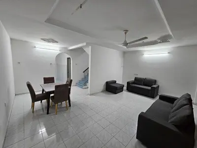 a living room with a couch and a table and chairs at Double S Hostel in Ipoh