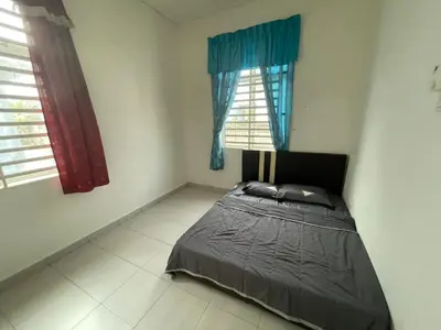 a bedroom with a bed and two windows at MDRS Seroja 7 in Kuala Ketil