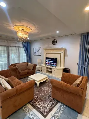 a large living room with couches and a tv at Anandavilla in Seri Manjung