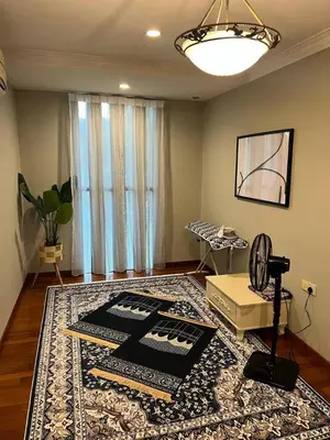 a living room with a table and a rug at Anandavilla in Seri Manjung