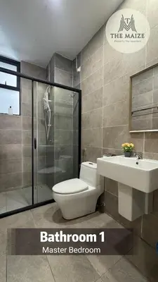 a bathroom with a toilet and a sink and a shower at Verdant Sunset The Cove Ipoh in Ipoh