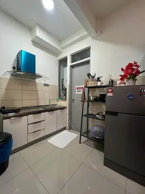 a kitchen with a sink and a refrigerator at Shahiqa Homestay Cameron Highland in Brinchang