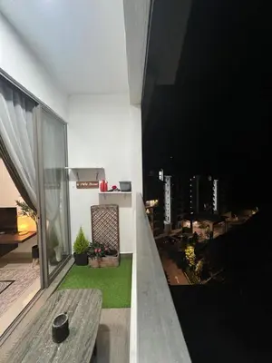 a balcony with a table and a view of a city at Shahiqa Homestay Cameron Highland in Brinchang