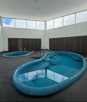 a swimming pool with a slide in a building at Shahiqa Homestay Cameron Highland in Brinchang