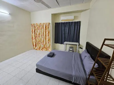 a bedroom with a bed and a window at May Flower Hostel in Ipoh