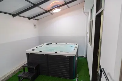a hot tub in a room with green grass at Georgetown Stylish Design Jacuzzi KTV 5BR 16pax D in George Town