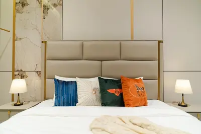 a bedroom with a white bed with pillows and two lamps at Georgetown Elegant Golden Jacuzzi KTV 5BR 16pax E in George Town