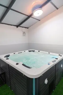 a hot tub in a room with green grass at Georgetown Elegant Golden Jacuzzi KTV 5BR 16pax E in George Town