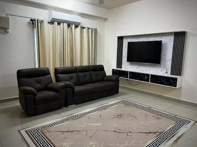 a living room with a couch and a television at Homestay Adyana in Raub