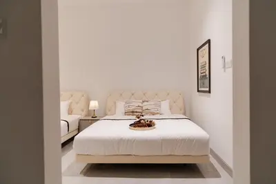 a bedroom with a white bed with a bowl on it at Georgetown Italian-Style Jacuzzi KTV 5BR 18pax G in George Town