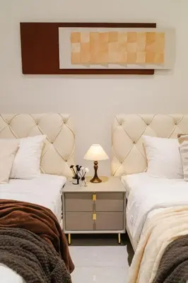 a bedroom with two beds and a table with a lamp at Georgetown Italian-Style Jacuzzi KTV 5BR 18pax G in George Town