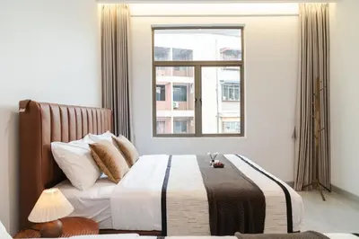 a bedroom with a bed with a window at Georgetown Modern Brown-Colored KTV 5BR 18pax H in George Town