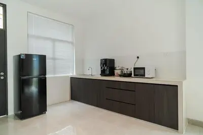 a kitchen with a black refrigerator and a counter at Georgetown Modern Brown-Colored KTV 5BR 18pax H in George Town