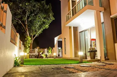 a courtyard of an apartment building at night at 2 Spacious Lupsxury conor villa garden Parking group family gathering wedding in Gelugor