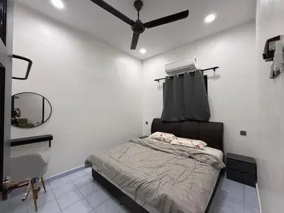 a bedroom with a bed and a ceiling fan at raub homesty in Raub