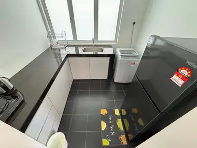 a small bathroom with a sink and a trash can at Spacious 4BR Family Suites in George Town in George Town