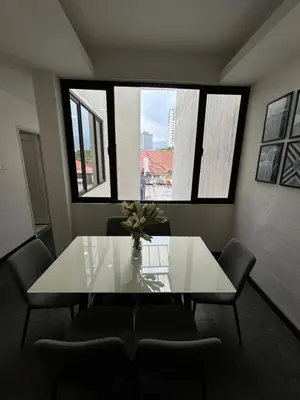 a dining room with a white table and chairs at Spacious 4BR Family Suites in George Town in George Town