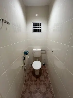 a small bathroom with a toilet and a window at Raub homesty in Raub