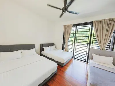 a bedroom with two beds and a ceiling fan at 142 spacious 3storey 6BR 6bath for big family wedding birthday easy parking in Gelugor