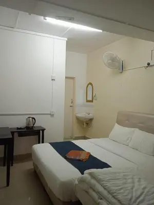 a bedroom with a bed and a sink in it at Cool view hotel in Tanah Rata