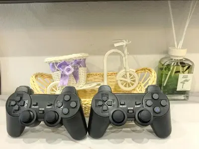 two video game controllers sitting next to a basket at 32 Homestay in Teluk Intan