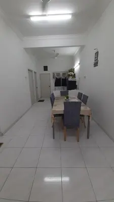 a dining room with a table and chairs in a room at Glory Homestay Ipoh in Ipoh