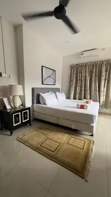 a bedroom with a large bed and a ceiling fan at Villa Alyana in Ipoh