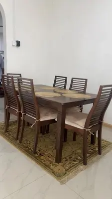 a wooden table with four chairs around it at Villa Alyana in Ipoh