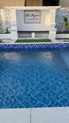 a swimming pool with a bench in the middle of it at Villa Alyana in Ipoh