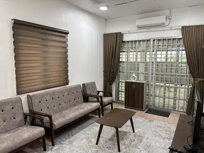 a living room with two couches and a table at Rafeeqs Homestay in Teluk Intan