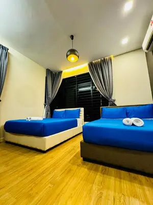 two beds in a room with blue pillows at Perfect for Groups! 5BR Villa Near Beach BBQ 20Pax in Batu Ferringhi