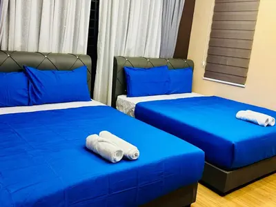 two beds in a room with blue sheets and blue pillows at Elegant20PaxVilla Perfect Location NearBeachMarket in Batu Ferringhi