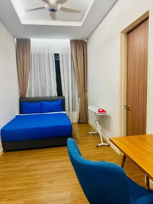 a bedroom with a blue bed and a table and chairs at Elegant20PaxVilla Perfect Location NearBeachMarket in Batu Ferringhi