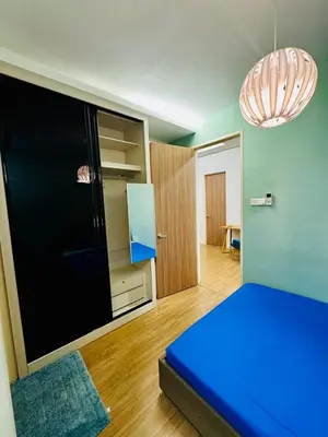 a small room with a blue bed and a closet at Beautiful 20-Person Villa, Walk to Beach & Market in Batu Ferringhi