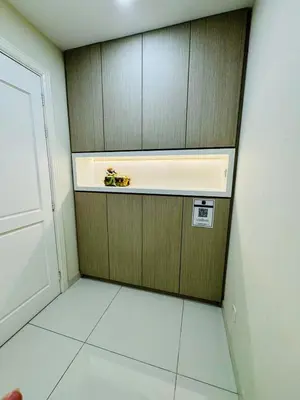 a kitchen with wooden cabinets and a white tile floor at Beautiful 20-Person Villa, Walk to Beach & Market in Batu Ferringhi