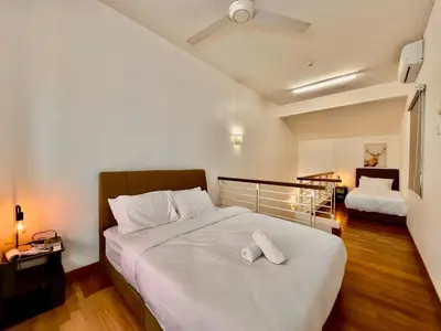 a bedroom with a large bed with white pillows at Cozy Homestay in Karpal Singh by 3C in George Town