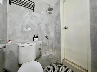a bathroom with a toilet and a shower at Cozy Homestay in Karpal Singh by 3C in George Town