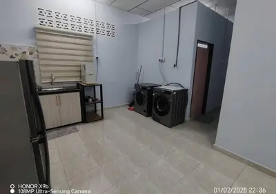 a room with two microwaves and a room with a kitchen at Homestay Zainab Sg Dua Mslim With 100mbps Wifi in Kepala Batas