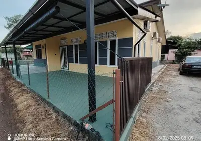 a fence in front of a house at Homestay Zainab Sg Dua Mslim With 100mbps Wifi in Kepala Batas
