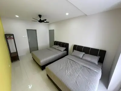 a bedroom with two beds and a ceiling fan at Forever Green cameron in Brinchang