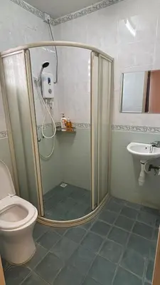 a bathroom with a shower with a toilet and a sink at Comfy21 Homestay Tambun, Ipoh in Ipoh