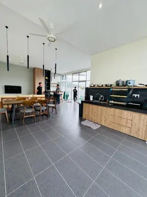 a room with tables and chairs and a ceiling fan at AYAAN PENTHOUSE at QUINTET 5 BED ROOM & ROOFTOP SKY DINING in Tanah Rata