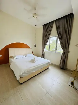 a bedroom with a large bed and a window at AYAAN PENTHOUSE at QUINTET 5 BED ROOM & ROOFTOP SKY DINING in Tanah Rata