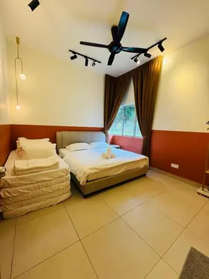 a bedroom with two beds and a ceiling fan at AYAAN SNOOKERS HOUSE at QUINTET FREE PARKING and NETFLIX in Tanah Rata