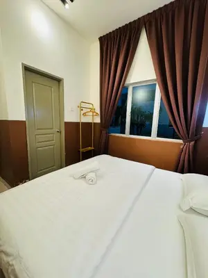 a bedroom with a large white bed and a window at AYAAN SNOOKERS HOUSE at QUINTET FREE PARKING and NETFLIX in Tanah Rata