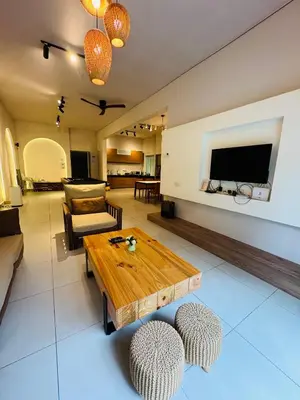 a living room with a wooden table and chairs at AYAAN SNOOKERS HOUSE at QUINTET FREE PARKING and NETFLIX in Tanah Rata