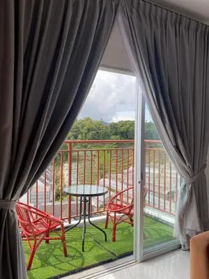 a balcony with a table and two chairs and a window at Chillrex Homestay Just come over Chill & Relax in Brinchang