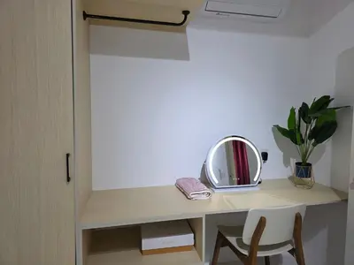 a dressing table with a mirror and a plant on it at Nature Beauty Homestay in Seri Iskandar